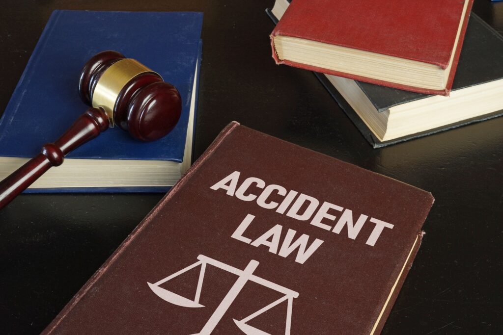 Accident law book with judge&rsquo;s gavel and legal textbooks on a desk, representing personal injury and accident law legal services
