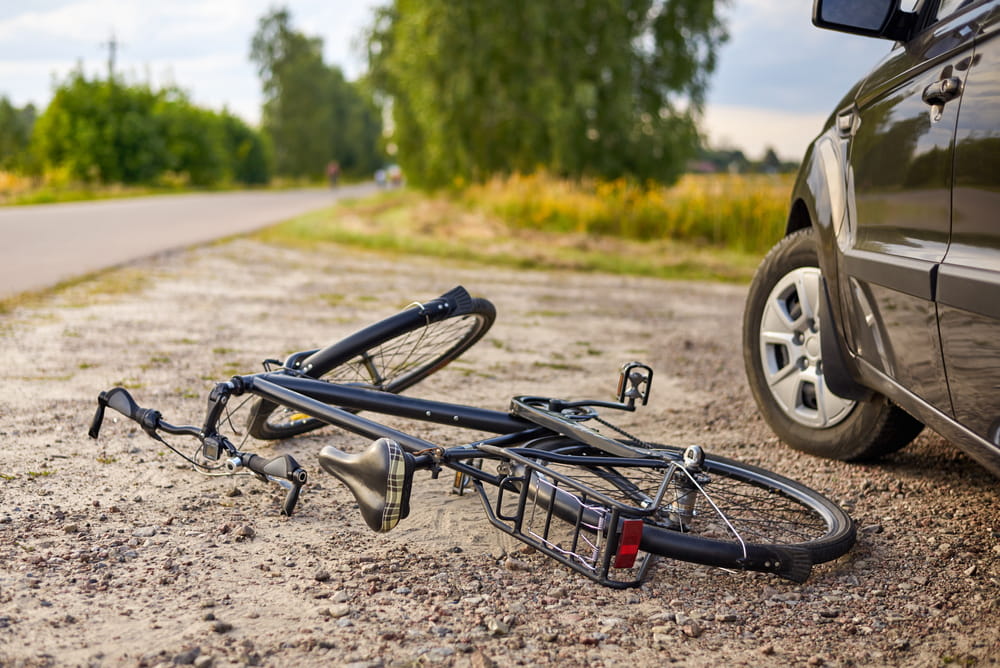 Bicycle lying beside a vehicle after a roadway collision