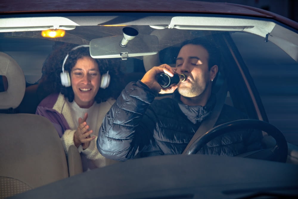 Driver drinking alcohol inside a vehicle before a potential DUI crash