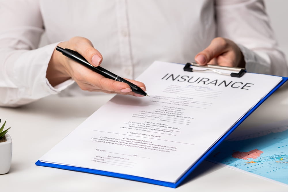 Person signing an insurance claim form after a bicycle accident in Coral Springs FL