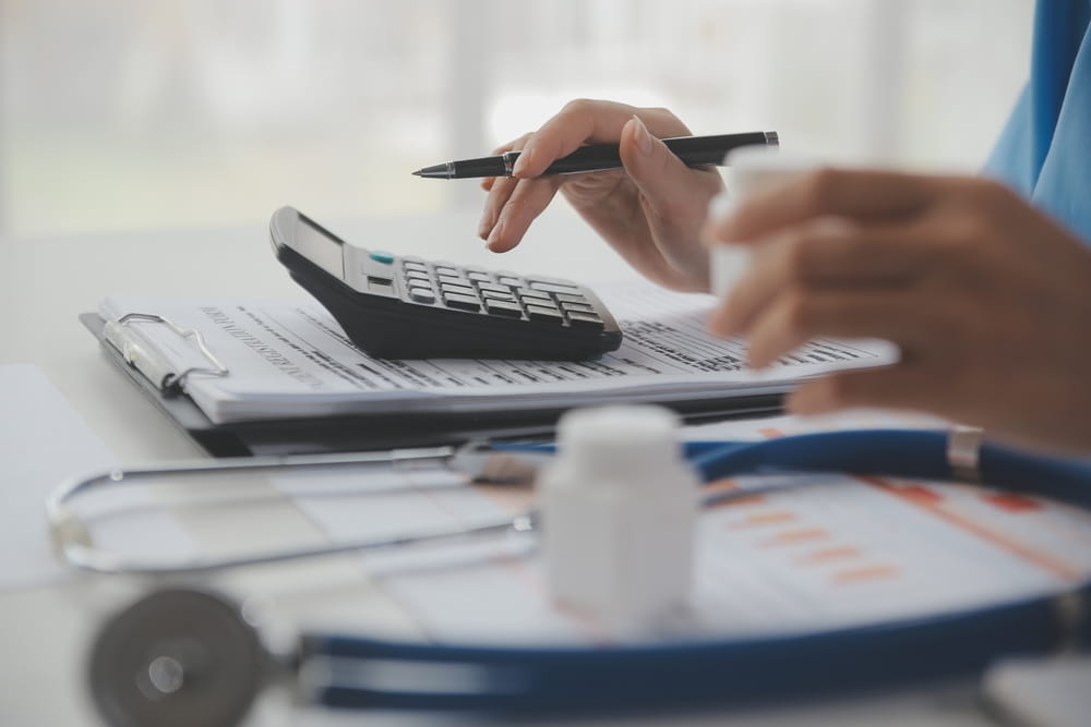Medical professional calculating costs from bicycle accident injuries with a stethoscope and documents in Coral Springs FL